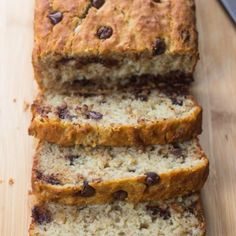 sliced loaf of banana bread sitting on top of a wooden cutting board