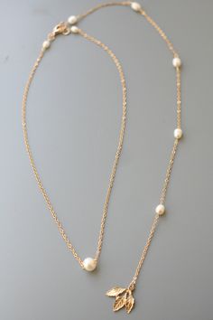 Pearl Bridal Necklace Backdrop Pearl Necklace Wedding Necklace Backdrop Rhinestone and Pearl Necklace, Crystal Bridal Necklace Backdrop leaght as 2 photo - 10 inch, as 6 photo - 5 inch. This elegant style necklace is created with Freshwater pearls in ivory/cream, brass leaves. Please choose desired length and color at checkout. Perfect for elegant bride! Gold Backdrop Necklace With Pearl Chain For Wedding, Gold Pearl Chain Backdrop Necklace For Wedding, Gold Wedding Backdrop Necklace With Pearl Chain, Dangle Pearl Necklace With Delicate Chain For Wedding, Gold Backdrop Necklace With Pearl Charm For Wedding, Gold Drop Necklace With Pearl Charm For Wedding, Pearl Bridal Necklace With Delicate Chain For Wedding, Dainty Single Strand Jewelry For Wedding, Dainty Dangle Necklaces For Wedding