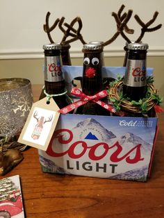 an assortment of beer bottles and reindeer antlers on a table