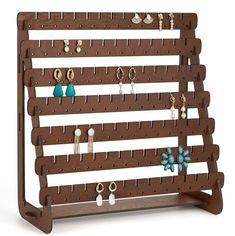 a wooden jewelry rack with earrings hanging from it's sides and hooks on the bottom