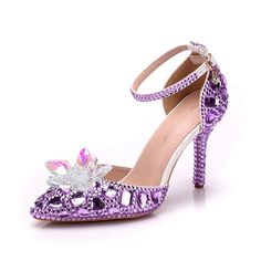 The Women's Crystal Queen Heel Sandal is a stunning and glamorous shoe that is sure to make a statement Made from high-quality materials, this sandal features a clear strap adorned with sparkling crystals that catch the light with every step. The heel of the shoe is also adorned with crystals, adding an extra touch of elegance and luxury.  Despite its high heel, the sandal is designed for comfort, with a padded insole and secure ankle strap. Perfect for a special occasion or a night out on the town. Crystal Ankle Strap Heels For Evening, Elegant Crystal Sandals For Spring, Summer Crystal Heels With Rhinestones, Summer Crystal High Heels, Crystal High Heel Shoes For Spring, Crystal Heels For Summer Evenings, Crystal Heels For Summer Evening, Spring Crystal High Heels, Crystal Open Toe Heels For Prom