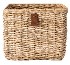 a large woven basket with leather handles on the bottom and sides, sitting against a white background