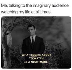 a man in a suit standing next to a tree with the caption'me talking to the imaginary audience watching my life at all times '