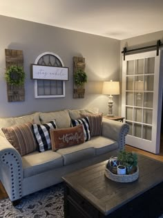 a living room filled with furniture and pillows on top of a table next to a door