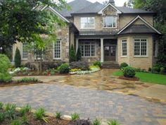 a large brick house with landscaping around it