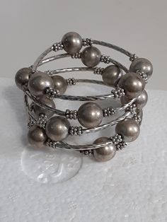 Very good condition Adjustable Multi-strand Polished Beads Bracelets, Adjustable Gray Metal Jewelry, Beaded Multi-strand Metal Bracelets, Silver Multi-strand Jewelry With Spacer Beads, Adjustable Metal Beaded Bracelets, Costume Jewelry, Silver Multi-strand Bracelets With Silver Beads, Silver Multi-strand Bracelets With Spacer Beads, Gray Beaded Multi-strand Jewelry, Silver Stretch Bracelet With Round Metal Beads