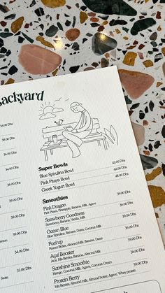 the menu for jackyard's restaurant is displayed on a table with other items