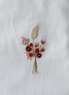 a white cloth with flowers embroidered on it