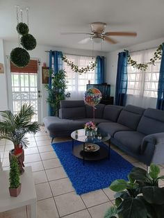 a living room filled with furniture and plants