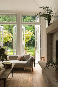 a living room filled with lots of furniture next to a fire place in a house