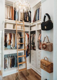 the closet is full of clothes and handbags, with a ladder leading up to it