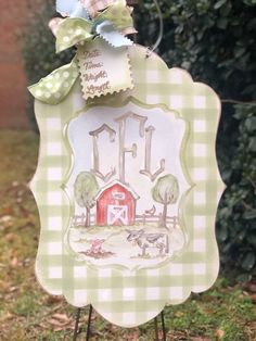 a green and white sign with a farm scene on it