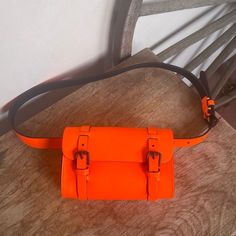 Ralph Lauren Polo Cute Bright Neon Orange Small Belt Bag Or Shoulder Bag. It Is Adjustable Depending On Placement Of Belt Strap. Bag Can Also Be Taken Off To Wear Belt Without It. Double Buckle Closure. Unisex Size M. This Item Is Very Rare. I See No Other Rl-Polo Belt Bag In This Color Online. Measurements: Approximate Bag Length: 6.5” Bag Height: 4.5” Depth: 2” Belt Total Length: 39.5” Tightest: 31” Loosest: 25” Condition: **Preowned Only Worn Once. **From A Smoke Free Home. **Only Flaw Noted Is A Black Dot On Front On Bag Which Is Covered And No Seen When Closed. **Please See All Pictures And Measurements. **Please Ask Any Questions You Might Have. Orange Leather Pouch Shoulder Bag, Designer Orange Leather Shoulder Bag, Designer Orange Shoulder Bag For Daily Use, Luxury Orange Pouch Shoulder Bag, Designer Orange Satchel Shoulder Bag, Black Dots, Neon Orange, Belt Bag, Orange Black