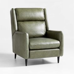 a green leather recliner chair sitting on top of a white floor