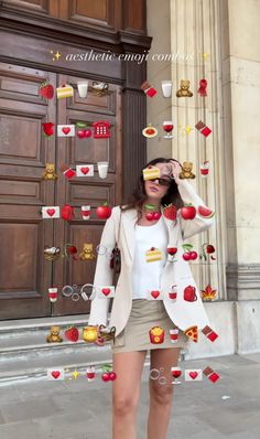 a woman standing in front of a building with lots of food hanging from the ceiling