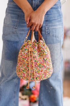 a person holding a handbag with sprinkles on it