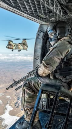 a man sitting in the cockpit of an airplane with a helicopter flying over him and another person standing next to him