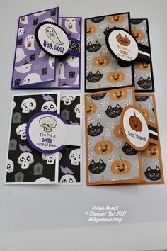 four halloween cards with pumpkins and ghost faces on them, all in different colors