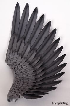 a bird made out of black feathers on a white background