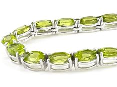 52.95ctw oval peridot rhodium over sterling silver tennis necklace. Measures approximately 3/16"W. Box clasp with safety. Oval Peridot Jewelry For Formal Occasions, Formal Oval Peridot Jewelry, Silver Oval Peridot Jewelry, Silver Peridot Oval Jewelry, Oval Peridot Silver Jewelry, Lime Green Gemstone Jewelry For Formal Occasions, Formal Lime Green Gemstone Jewelry, Box Clasp, Peridot Gemstone