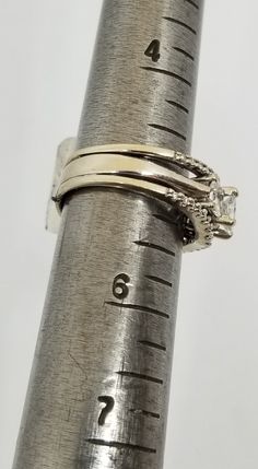 "We do not check prongs for wear or stones for looseness. All items are sold as is-noting that we are a resale shop so everything here had a previous owner! We will include flaws in the description when noted. This is one of the reasons our items are more affordable than new at a jewelry store. Vintage 14K White Gold Fused 3 Band Ring Set with 1 TCW Diamonds, Size 5.25. Stamped 14 KT and some lettering I can't make out. The Diamond(s) have been soft graded I1;I2 by the jewelry shop we use for re Stackable Emerald Cut White Gold Rings, Formal Fine Jewelry Stackable Three-stone Rings, White Gold Stackable Emerald Cut Wedding Ring, White Gold Emerald Cut Stackable Rings, Classic Stackable Marquise Cut Jewelry, Sterling Silver Three Stone Baguette Cut Ring, 14k Gold Three Stone Baguette Cut Jewelry, Stackable Emerald-cut Diamond Anniversary Ring, Stackable Emerald Cut Diamond Anniversary Ring