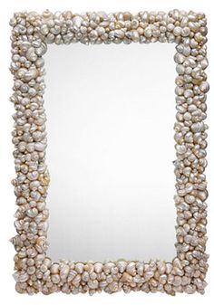 a mirror made out of shells on a white background