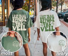 two women wearing matching tshirts walking down the street with their back to each other