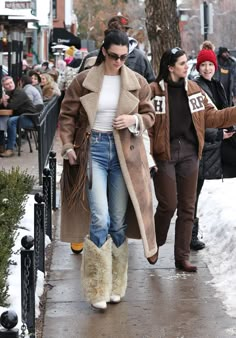 two women walking down the sidewalk in winter