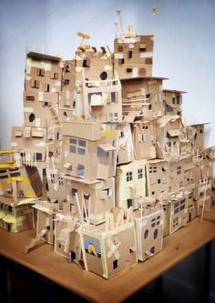 cardboard houses are stacked on top of each other