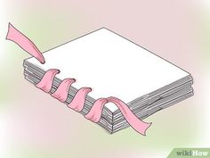 a stack of books with pink ribbon tied around them