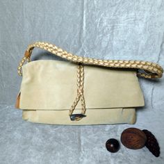 Vintage Burberry Haymarket Tan Suede Leather Braided Bag, Suede Haymarket Check Horn Toggle clasp Shoulder Bag This is an authentic BURBERRY Suede Haymarket Check Horn Toggle Shoulder Bag. This classic shoulder bag is finely crafted of soft tan suede with Burberry Nova check side panels. The bag features a woven leather shoulder strap with a cross-over frontal flap and a horn toggle closure . The fabric interior is spotless with one side zipper pocket.  There is discoloration on the corners from wear. This is a marvelous shoulder bag for everyday wear, from Burberry! Length: 15.00 in Width: 3.00 in Height: 10.00 in Drop: 9.00 in Formal Rectangular Hobo Bag With Braided Handles, Beige Leather Bag With Fold Over Clasp, Beige Leather Satchel Fashion Accessory, Evening Leather Shoulder Bag In Natural Color, Natural Leather Shoulder Bag For Evening, Leather Shoulder Bag With Fold Over Clasp, Elegant Handmade Hobo Bag For Travel, Vintage Leather Shoulder Bag With Magnetic Closure, Braided Bag