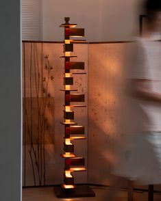 a tall wooden sculpture sitting in the middle of a room