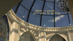 the inside of a building with a large glass dome and writing on it's side