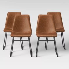 three brown leather chairs sitting next to each other