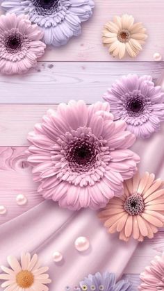 an image of colorful flowers on pink and white wood planks with pearls in the background