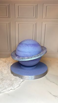 a purple hat sitting on top of a blue plate