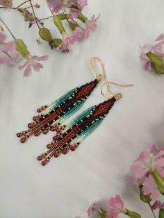 I wanted to make a series of really cute, neat and stylish earrings that can be worn every day with almost any outfit. This pair is made of the smallest Japanese Miyuki seed beads, Miyuki drops and gold plated ear wires. They are comfortable and lightweight. Turquoise and brown color pallet looks even more interesting thanks to the black, beige and gold colors. Hope you will enjoy wearing them. Turquoise And Brown, Earrings Patterns, Bead Fringe, Brown Earrings, Seed Bead Patterns, Stylish Earrings, Artisan Earrings, Gold Colors, Bead Work Jewelry