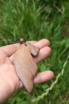 a hand holding a tiny animal in it's palm