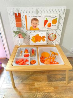 a wooden table topped with trays filled with fruit and veggies on top of it