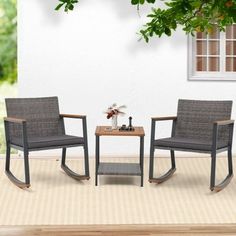 two chairs sitting on top of a rug next to a table