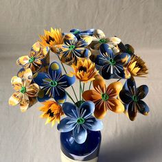 a blue vase filled with colorful flowers on top of a table