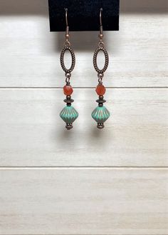 "Long boho dangle earrings created using Czech glass bicone beads in matte turquoise with etched copper accents, burnt orange Czech fire polish glass beads, small copper beads, and spacer beads.  These are wire-wrapped to antique copper oval connectors.  Total length of earrings, including the ear wire, is approximately 2-1/2\". Matching necklace: https://www.etsy.com/listing/1519124092/beaded-bohemian-necklace-with-copper?click_key=5b35150b8614b4eac85f62531910e6638ba2c2a0%3A1519124092&click_sum Bohemian Czech Glass Earrings With Ear Wire, Bohemian Czech Glass Dangle Earrings, Bohemian Nickel Free Czech Glass Earrings, Bohemian Nickel-free Czech Glass Earrings, Bohemian Czech Glass Drop Earrings, Bohemian Czech Glass Crystal Earrings Nickel Free, Bohemian Crystal Earrings With Adjustable Czech Glass, Bohemian Czech Glass Crystal Earrings Adjustable, Bohemian Crystal Earrings With Adjustable Fit