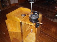 a small wooden table with an electric device on top