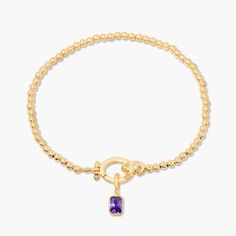 Treat your wrists to some bling with the Mackenzie Birthstone Bracelet. With a vivid birthstone charm, and intricately-beaded gold, this sparkling accessory is sure to add a touch of glam to any outfit. Avery Bracelet: Available in 14k gold plated or rhodium plated brass, 6" bead bracelet, hinge closure measures 1/2", 4mm beads Mackenzie Hinge Birthstone Charm: Available in 14k gold plated sterling silver or rhodium plated sterling silver1/8"x1/4" charm, 5mm Cubic Zirconia NOTE - open bracelet h Elegant Gold Charm Bracelet With Birthstone, Gold Beaded Bracelets With Gemstone Accents, Adjustable Gold Beaded Bracelets With Gemstone Accents, Elegant Gold Crystal Bracelet With Birthstone, Elegant Gold Beaded Bracelets With Gemstone Accents, Elegant Gold Crystal Birthstone Bracelet, Gold Charm Bracelet With Birthstone, Gold Bracelets With Gemstone Accents And Round Beads, Elegant Jeweled Beaded Bracelets For Gift