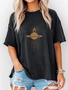 This Celestial Saturn Cross Tee is a boho-inspired shirt featuring the mount of Saturn planet design. Made with Comfort Colors fabric, this unisex Garment-Dyed Tee provides a relaxed fit and a crew neckline, making it perfect for casual and semi-formal settings. Ideal for those who love celestial designs, this tee is great for everyday wear and can be accessorized for a unique touch. Perfect for astrology enthusiasts and those who appreciate ethically sourced US cotton fabric. Great for holidays, celebrations, and occasions that celebrate the cosmos. Product features - Available in multiple sizes from S to 4XL - Double-needle stitching for durability - Garment-dyed fabric for soft color and texture - Ethically sourced US cotton - Relaxed fit and crew neckline for comfort and style Care ins Bohemian Tops With Screen Print, Relaxed Fit, Bohemian Tops With Screen Print And Relaxed Fit, Bohemian Shirt With Relaxed Fit And Crew Neck, Free-spirited Cotton Crew Neck Top, Bohemian Shirt With Graphic Print And Relaxed Fit, Black Bohemian T-shirt With Relaxed Fit, Black Bohemian Relaxed Fit T-shirt, Bohemian Relaxed Fit T-shirt For Festival, Bohemian Cotton Tops With Graphic Print