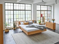 a large bed sitting inside of a bedroom on top of a rug