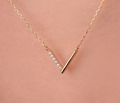 Our v shaped necklace is 14k solid gold and it has charming zircon stones that one side of the v shaped. With its minimalist and dainty style you can wear it everyday. If you consider this chevron necklace as a gift, it makes your loves happy on their birthdays, anniversaries, graduations, mother's day. valentine's day, or women's day. 🎁 We can add a gift note for your loved ones. It arrives in a special jewelry gift box. ✨ We respond to your questions happily. Your question will be answered wi V Shaped Necklace, V Necklace, Cloisonne Jewelry, Chevron Necklace, Face Necklace, Gold Chevron, Symbol Necklace, Sterling Silver Initial, Solid Gold Necklace