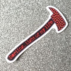 a red and black sticker with the words delirie life on it's blade