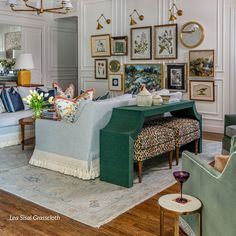 a living room filled with furniture and pictures on the wall