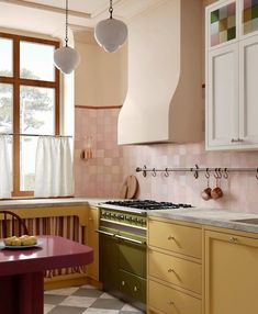 a kitchen with an oven, stove and table in it's center island next to a window